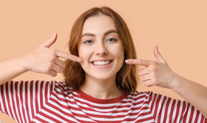 A girl showing teeth.