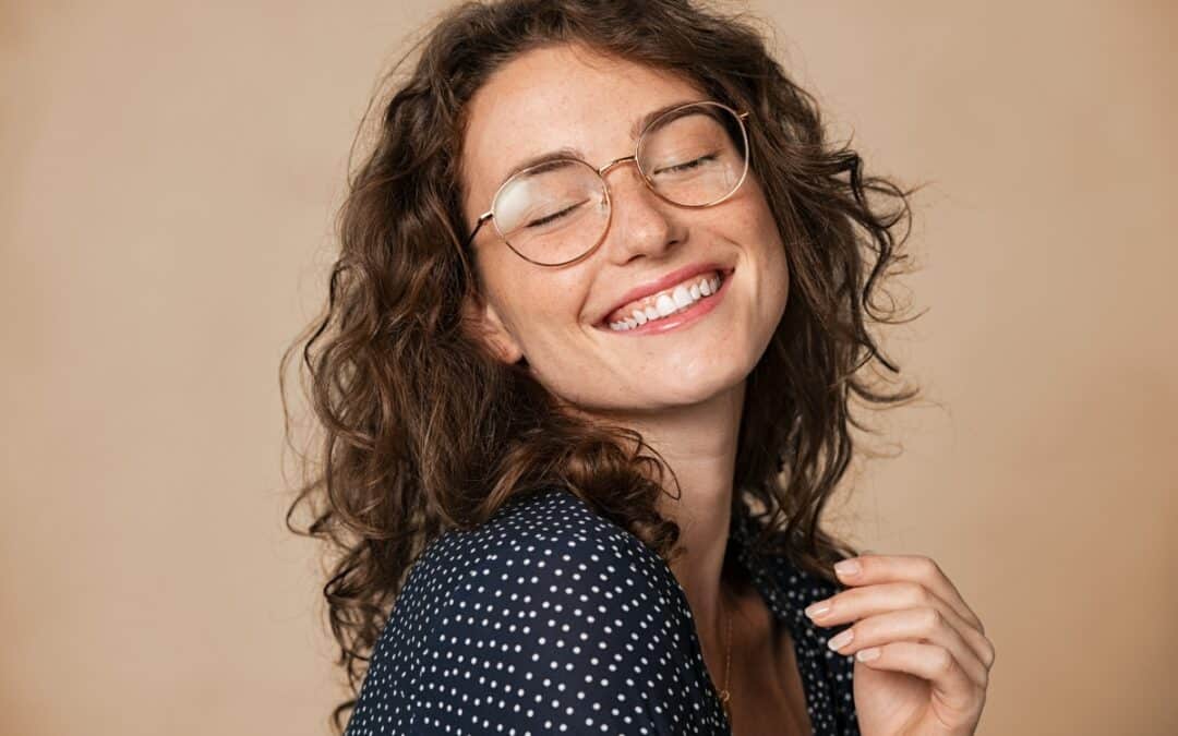 woman showing how cosmetic dentistry transform her life